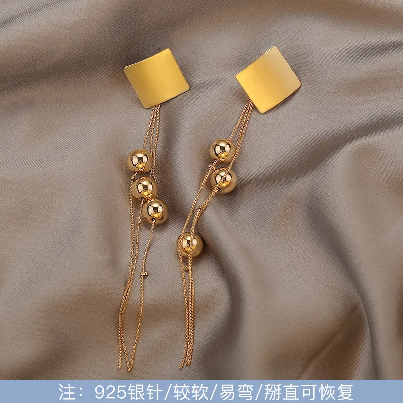 Golden Orbit Ball Tassel Earrings